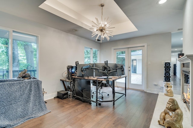 2414 Glenshire Ln, Tallahassee, FL 32308 - dining room with wood finished floors, a chandelier, a tray ceiling, and baseboards