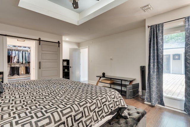 2414 Glenshire Ln, Tallahassee, FL 32308 - bedroom featuring a barn door and wood finished floors