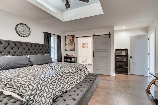 2414 Glenshire Ln, Tallahassee, FL 32308 - bedroom with a barn door, wood finished floors, connected bathroom, a ceiling fan, and recessed lighting
