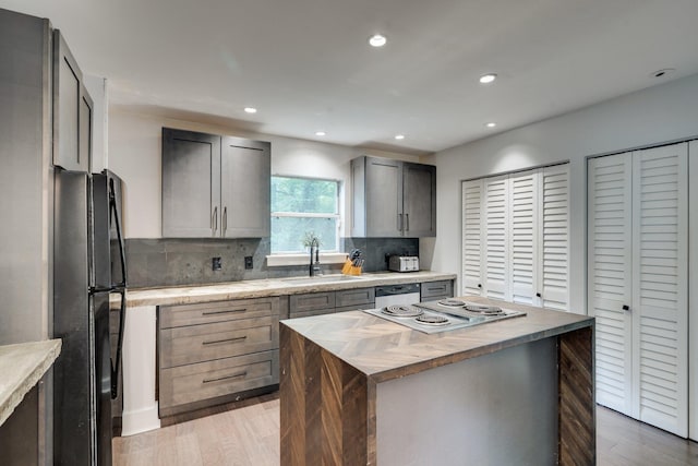 2414 Glenshire Ln, Tallahassee, FL 32308 - kitchen with freestanding refrigerator, wooden counters, a sink, electric stovetop, and a kitchen island