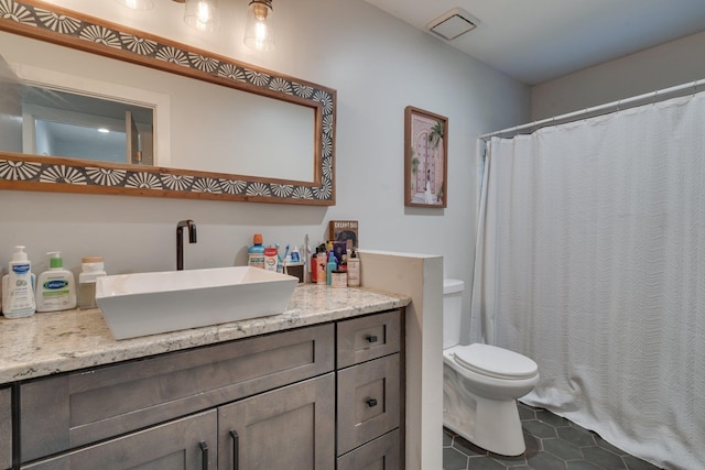 2414 Glenshire Ln, Tallahassee, FL 32308 - full bath featuring vanity, tile patterned flooring, toilet, and curtained shower