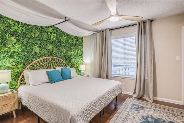 bedroom featuring ceiling fan, dark wood-type flooring, and a textured ceiling