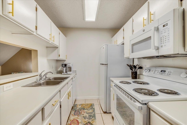 kitchen with white cabinetry, white appliances, sink, and light tile patterned floors