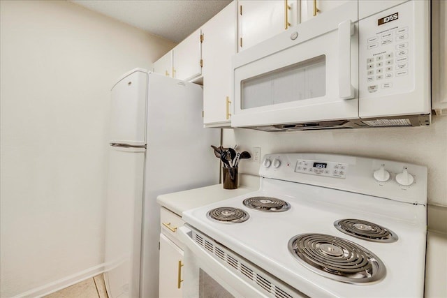 kitchen with white appliances and white cabinets