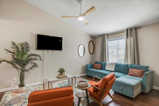 living room with a textured ceiling, lofted ceiling, ceiling fan, and dark hardwood / wood-style floors