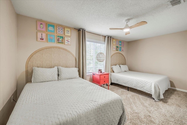 bedroom featuring carpet floors, a textured ceiling, and ceiling fan