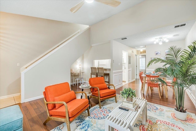 sitting room featuring ceiling fan, a textured ceiling, and hardwood / wood-style floors