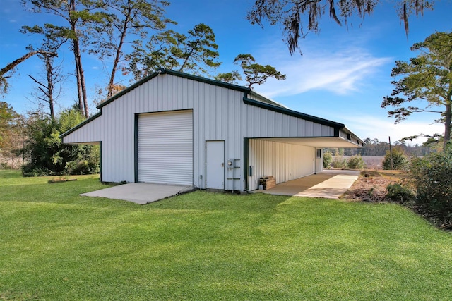 view of outdoor structure with a garage and a lawn