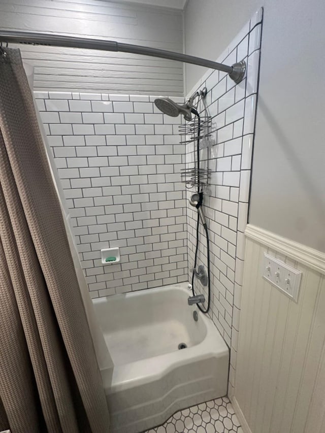 bathroom with shower / bath combo with shower curtain and tile patterned floors