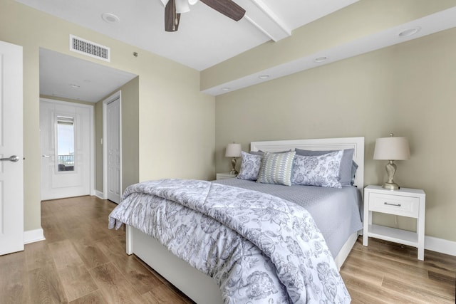 300 S Duval St Unit 1210, Tallahassee, FL 32301 - bedroom with beamed ceiling, wood finished floors, and a ceiling fan
