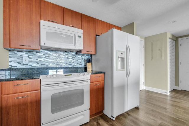 300 S Duval St Unit 1210, Tallahassee, FL 32301 - kitchen featuring white appliances, wood finished floors, tasteful backsplash, and dark countertops