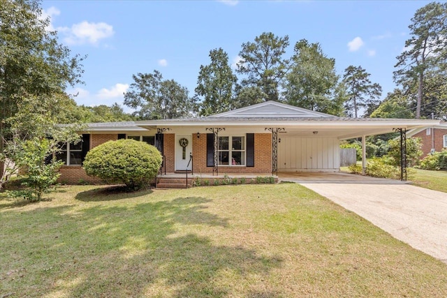 view of front of home featuring a front lawn, driveway, an attached carport, a porch, and brick siding