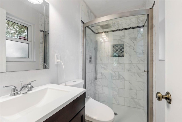 full bath featuring vanity, toilet, and a shower stall