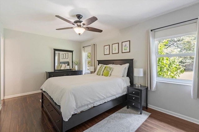 bedroom with dark wood-type flooring, baseboards, and ceiling fan