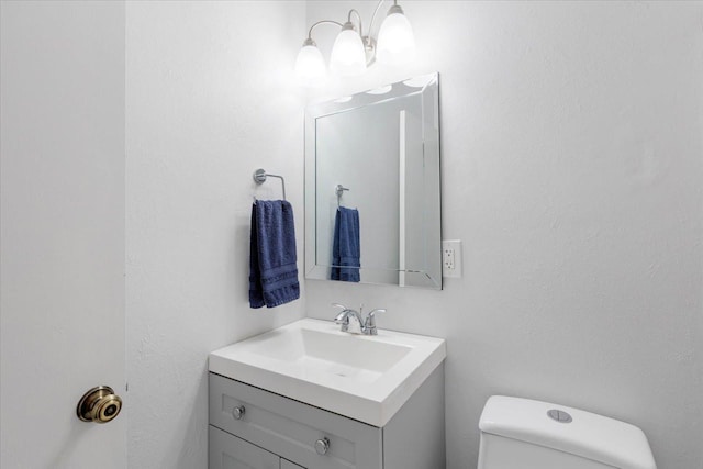 half bathroom featuring toilet and vanity