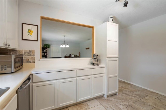 kitchen with light countertops, white cabinets, tasteful backsplash, and stainless steel appliances