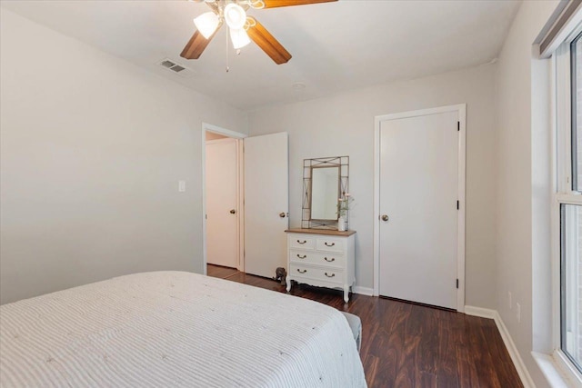 unfurnished bedroom featuring a ceiling fan, wood finished floors, visible vents, and baseboards