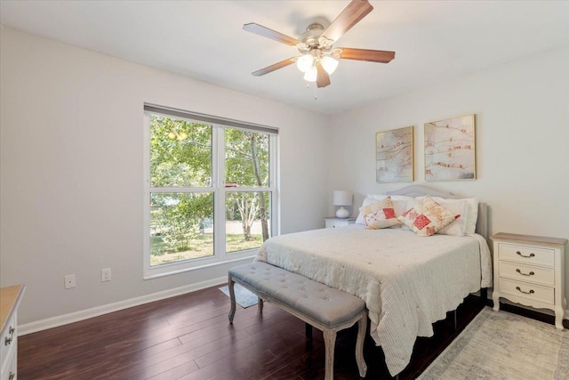 bedroom with baseboards, wood finished floors, and a ceiling fan