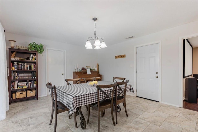 dining space with visible vents, baseboards, a chandelier, and stone finish flooring