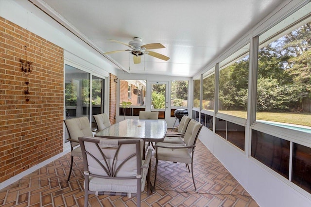 sunroom featuring ceiling fan