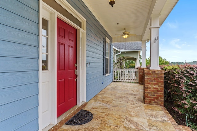 property entrance featuring ceiling fan and a porch