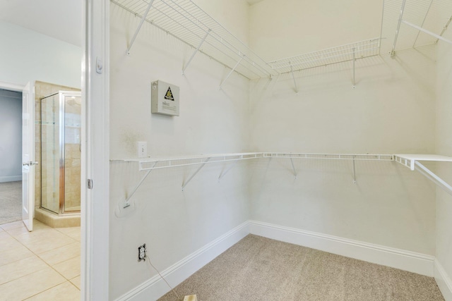 walk in closet featuring carpet and tile patterned flooring