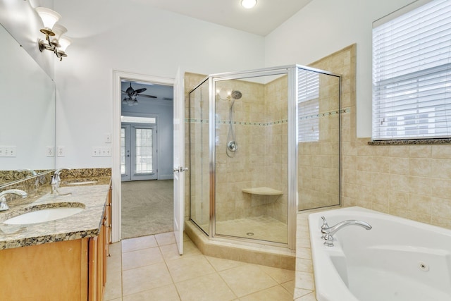 full bathroom with a stall shower, tile patterned flooring, a sink, and a bath