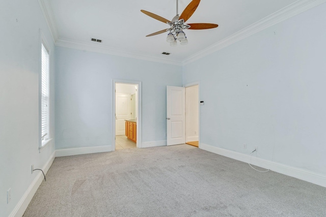 unfurnished bedroom featuring visible vents, baseboards, crown molding, and light colored carpet