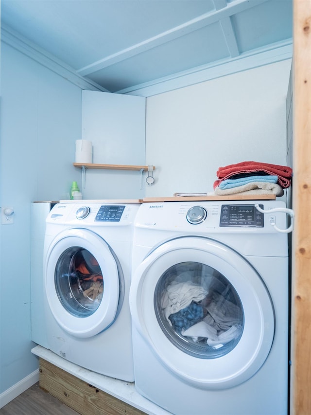 laundry room with laundry area, independent washer and dryer, and wood finished floors