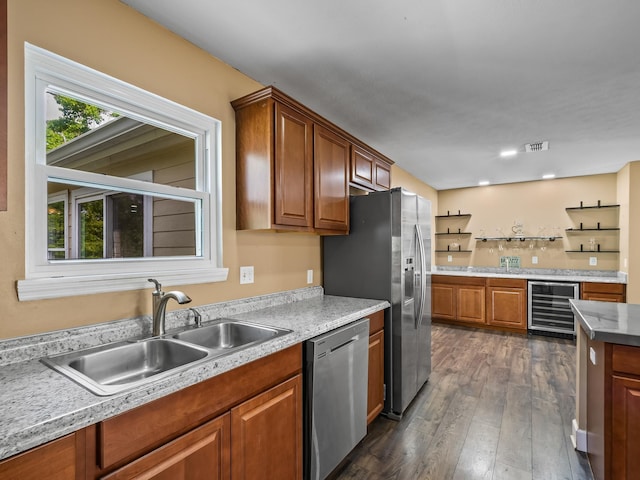 kitchen with a sink, wine cooler, visible vents, appliances with stainless steel finishes, and dark wood finished floors