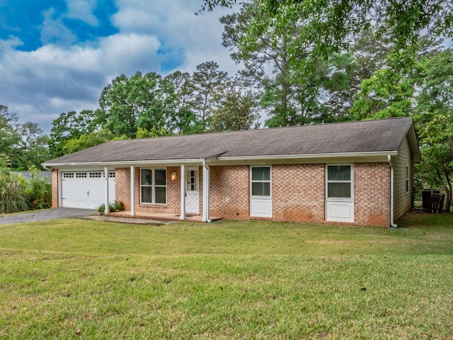 ranch-style home with a front yard, aphalt driveway, brick siding, and an attached garage