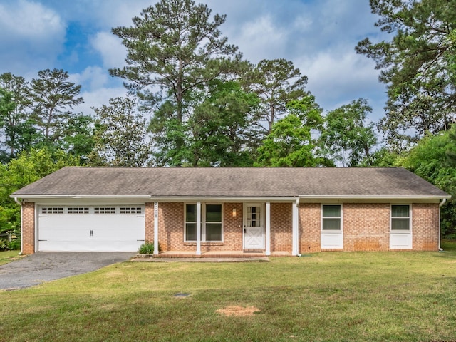 ranch-style home featuring a front yard, a garage, covered porch, aphalt driveway, and brick siding