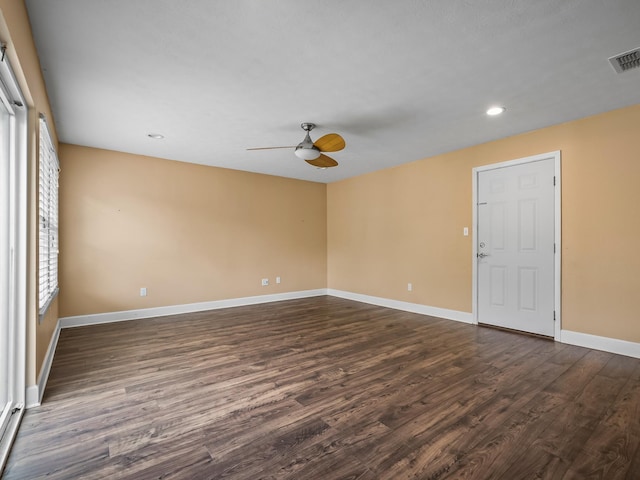 empty room with baseboards, recessed lighting, ceiling fan, dark wood-style floors, and visible vents