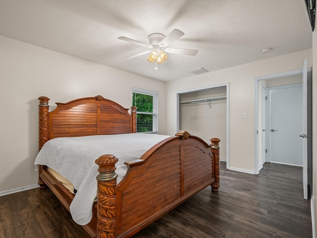 bedroom with visible vents, a closet, baseboards, wood finished floors, and a ceiling fan