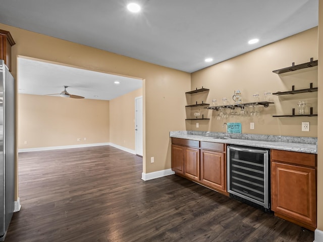 bar featuring recessed lighting, ceiling fan, dark wood-type flooring, wet bar, and beverage cooler