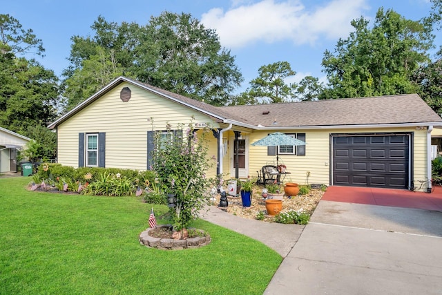 single story home featuring a garage and a front lawn