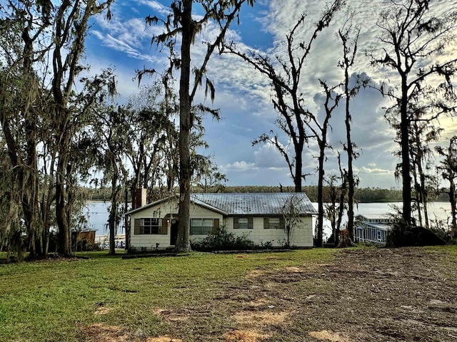 exterior space with a front lawn and a water view