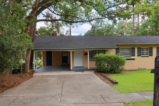 single story home featuring a carport and a front yard