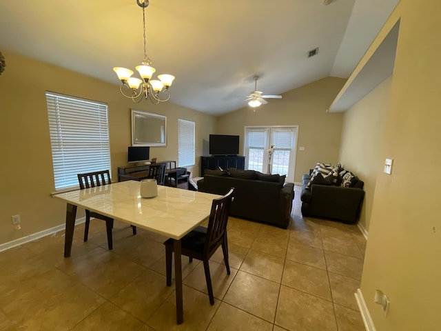 tiled dining area with vaulted ceiling and ceiling fan with notable chandelier