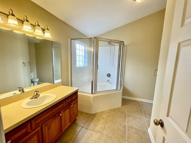 full bathroom featuring tile patterned floors, toilet, shower / bath combination with glass door, vaulted ceiling, and vanity