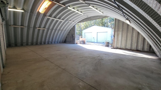 miscellaneous room featuring vaulted ceiling and concrete flooring