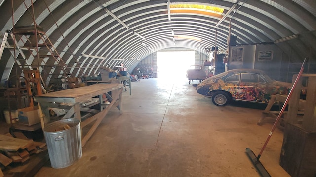 miscellaneous room featuring lofted ceiling and concrete flooring