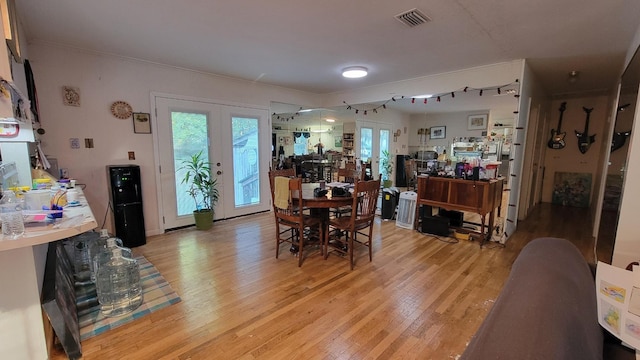 dining area with french doors and hardwood / wood-style floors