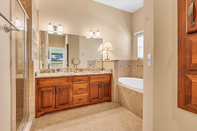 bathroom featuring vanity, tile patterned floors, and plus walk in shower