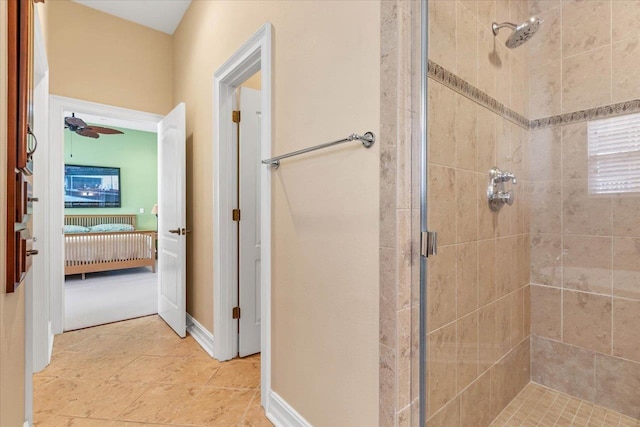 bathroom with ceiling fan, tile patterned flooring, and a shower with door