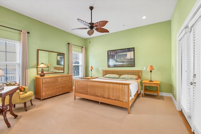 bedroom with light carpet and ceiling fan