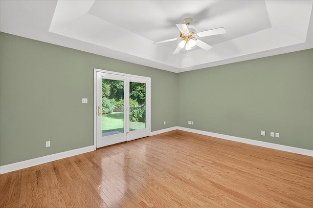 1913 Celtic Rd, Tallahassee, FL 32317 - spare room with a tray ceiling, baseboards, wood finished floors, and ceiling fan
