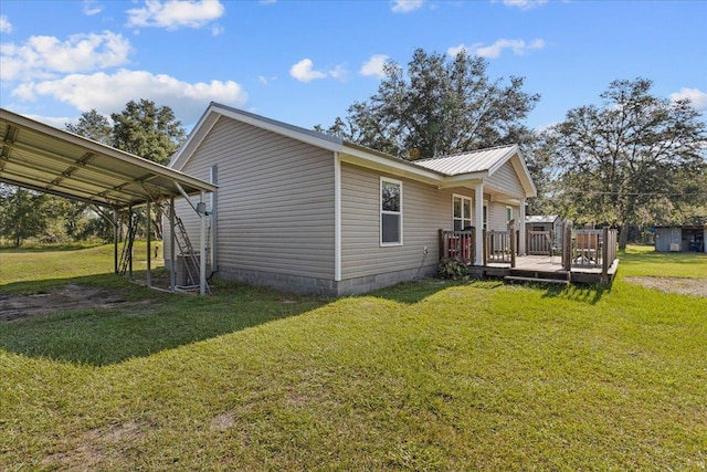 1439 W Lyman Hendry Rd, Perry, FL 32347 - view of property exterior with a deck, a lawn, a carport, and a metal roof