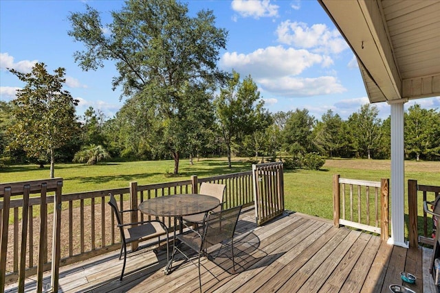 1439 W Lyman Hendry Rd, Perry, FL 32347 - wooden terrace featuring a lawn, outdoor dining space, and view of wooded area