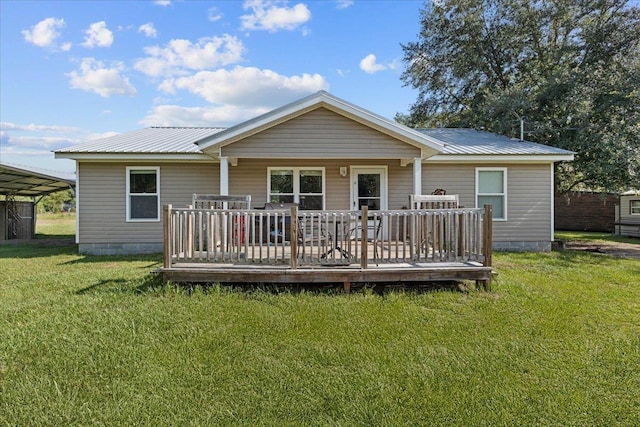 1439 W Lyman Hendry Rd, Perry, FL 32347 - rear view of house featuring a metal roof, a deck, and a lawn
